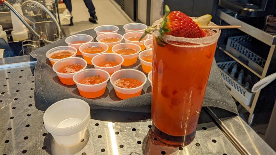 A strawberry frozen margarita and samples of strawberry lemonade