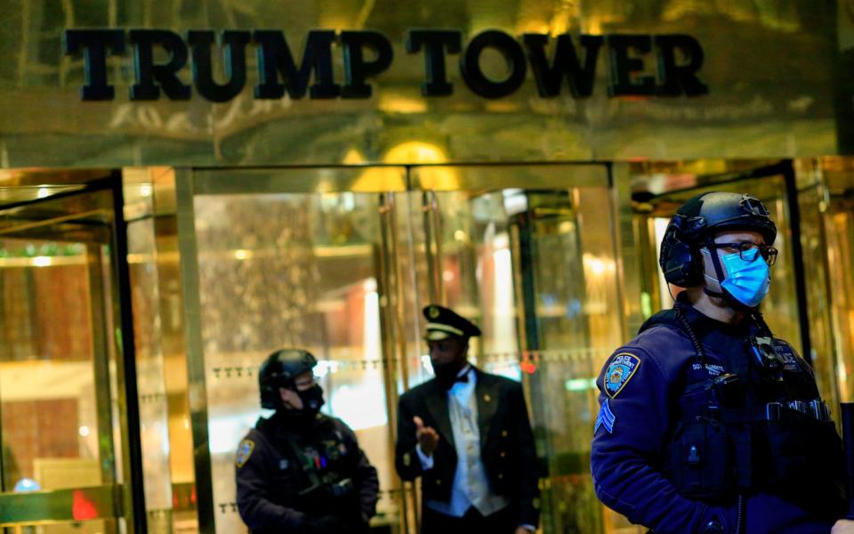 NYPD officers stand guard in front on Trump Tower  - AFP