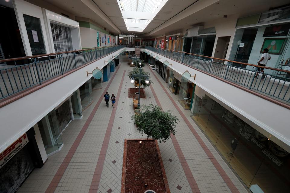 A few visitors walk around the otherwise quiet Savannah Mall.