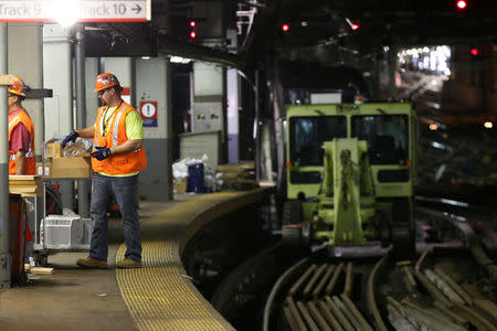 Amtrak track workers work inside the tunnel at New York's Pennsylvania Station which began track repairs causing massive disruptions to commuters in New York City, U.S., July 10, 2017. REUTERS/Brendan McDermid