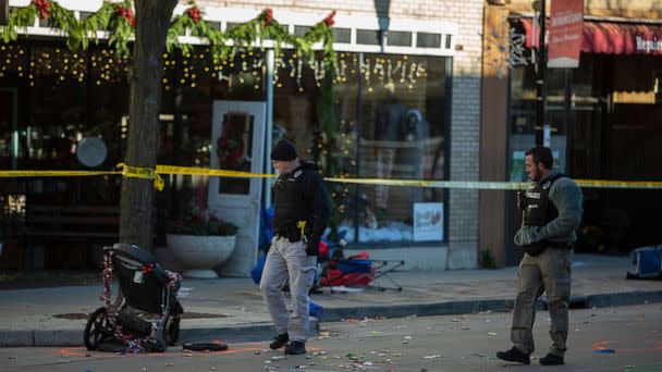 PHOTO: In this Nov. 22, 2021, file photo, police canvas debris left after a driver plowed into the Christmas parade on Main Street in downtown Waukesha, Wis. (Jim Vondruska/Getty Images, FILE)