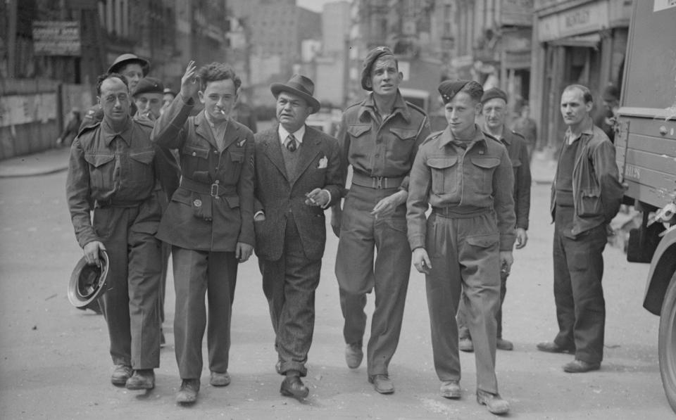 Edward G Robinson on a tour of war torn London with members of the British forces - Hulton Archive