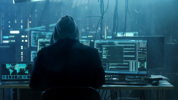 Hooded hacker at computer