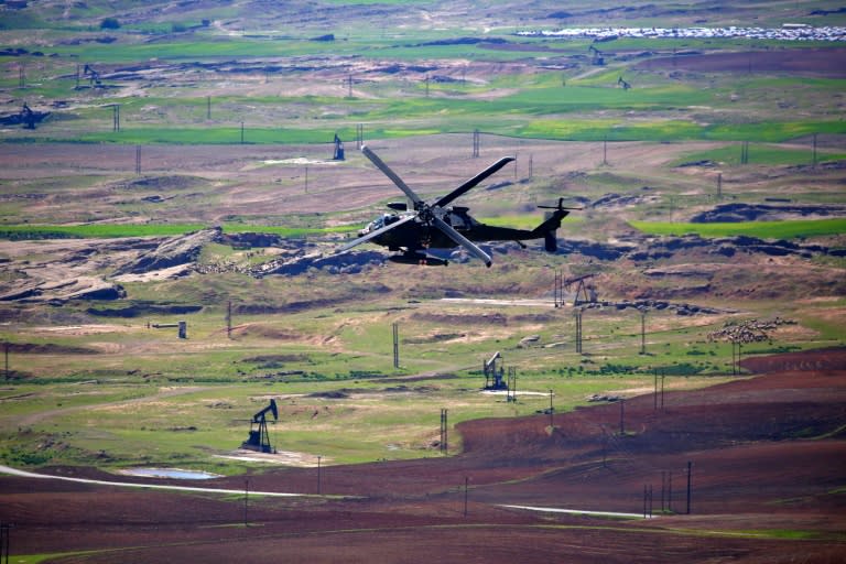 A medical helicopter, from the US-led coalition, flies over the site of Turkish airstrikes near northeastern Syrian Kurdish town of Derik on April 25, 2017