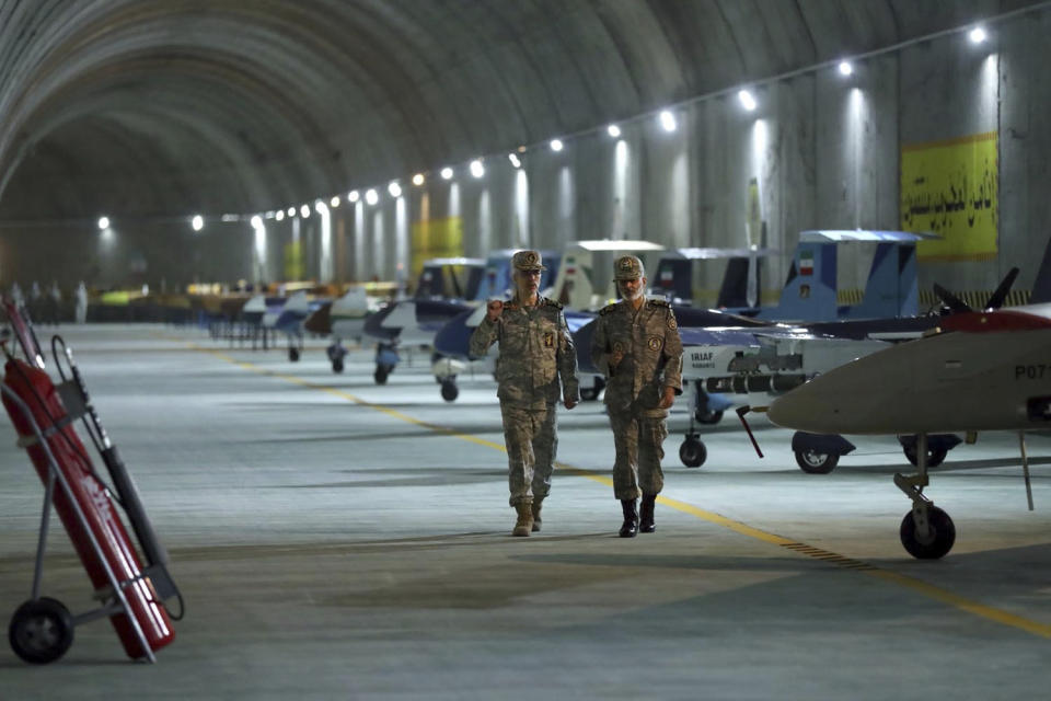 In this photo released on Saturday, May 28, 2022 by website of the Iranian Army, Chief of the General Staff of the Armed Forces Gen. Mohammad Hossein Bagheri, left, and Commander of the Army Gen. Abdolrahim Mousavi visit an underground drone base tunnel of the Army in the heart of the country's western Zagros Mountains. Iranian state television's report said Saturday, May 29 the tunnel was some 100 meters (330 feet) underground and was home to the Kaman-22 and Fotros drones, both capable of carrying cruise missiles. (Iranian Army via AP)