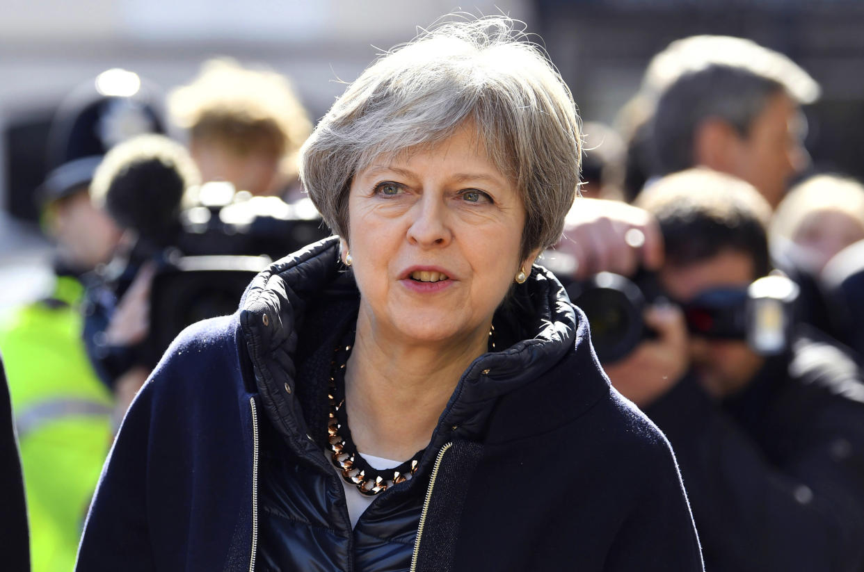 Theresa May views the area where former Russian double agent Sergei Skripal and his daughter were found critically ill in Salisbury. (Toby Melville/Pool Photo via AP)