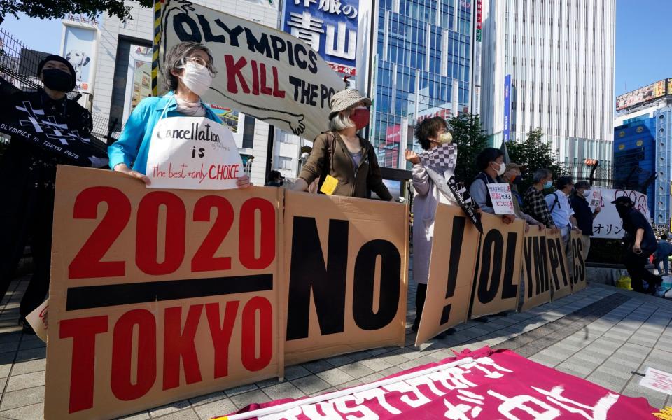 Protesters appeal to pedestrians during a demonstration against the Tokyo 2020 Olympic Games. After a three-day meeting the International Olympic Committee said the Olympic Games can be held this summer even if Tokyo is under a state of emergency due to the pandemic, but there is growing resistance in Japan - KIMIMASA MAYAMA/EPA-EFE/Shutterstock 