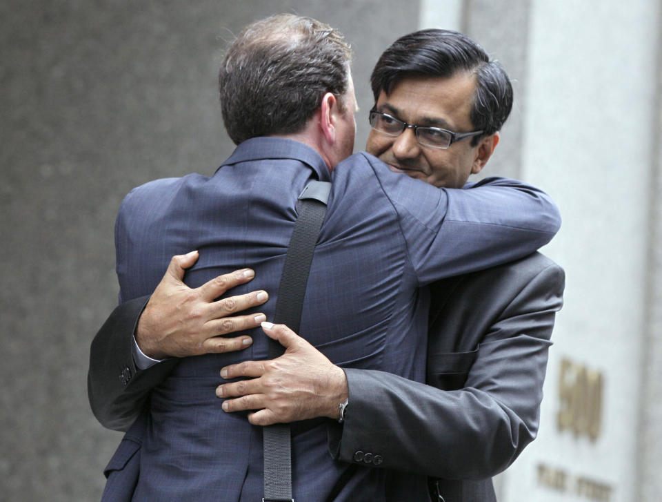 Anil Kumar, right, a former financial consultant-turned-government witness, hugs his attorney Gregory Morvillo as he leaves Federal Court in New York, Thursday, July 19, 2012. Kumar was sentenced Thursday to two years of probation after prosecutors credited him with helping convict a pair of Wall Street titans on insider trading charges. (AP Photo/Richard Drew)