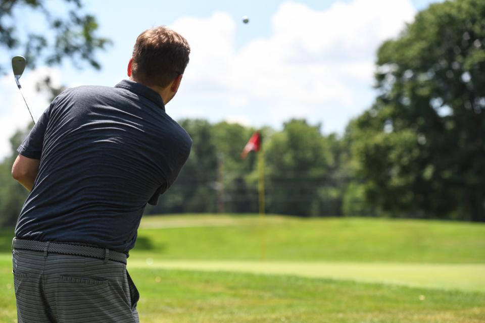 Ryan Lewis of the Akron Beacon Journal plays the 17th hole of Firestone Country Club’s South Course on Monday in Akron.