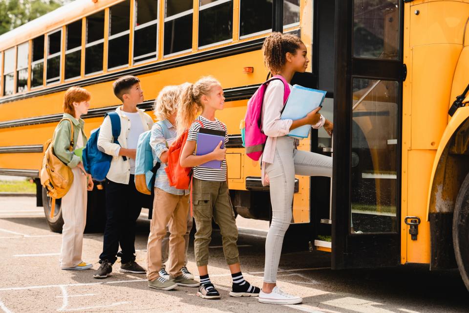 Students waiting in line to enter the bus.