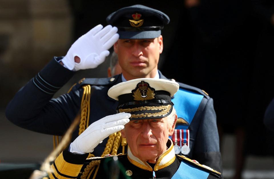 Britain's King Charles III and Prince William salute as they attend the state funeral and burial of Britain's Queen Elizabeth, in London, Monday, Sept. 19, 2022. (Hannah Mckay/Pool Photo via AP)