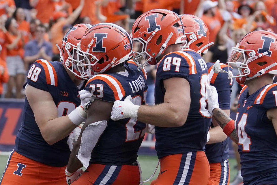 Illinois running back Reggie Love III (23) celebrates his touchdown with teammates during the first half of an NCAA college football game against Penn State, Saturday, Sept. 16, 2023, in Champaign, Ill. (AP Photo/Charles Rex Arbogast)