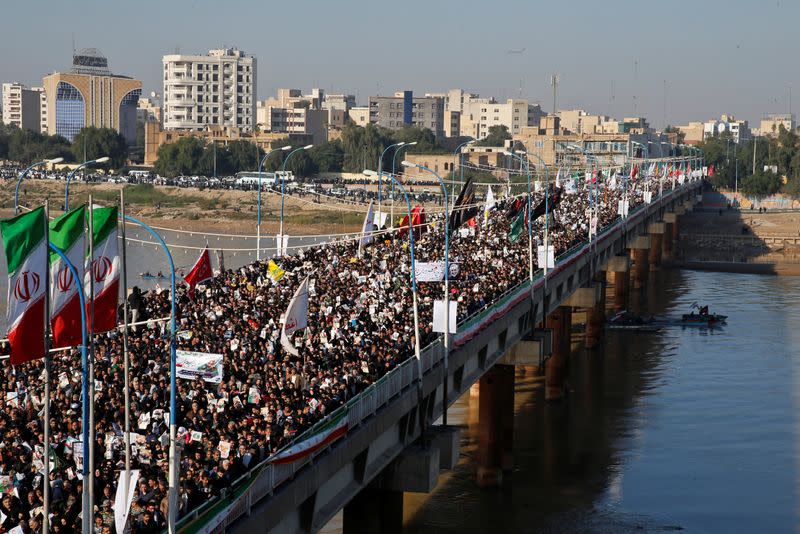 People attend a funeral procession for Soleimani and al-Muhandis, in Ahvaz