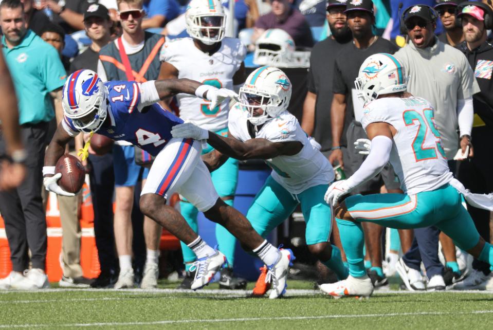 Bills receiver Stefon Diggs spins out of the grasp of Kadar Kohou and runs for a 55-yard touchdown on the play .