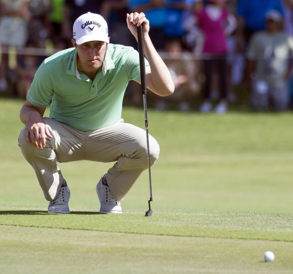 Chris Kirk lines up his putt on the first green during the fourth round of the Sony Open golf tournament at Waialae Country Club, Sunday, Jan. 12, 2014, in Honolulu. (AP Photo/Eugene Tanner)