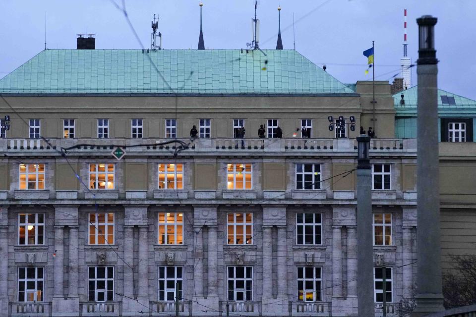 Police officers stand on the balcony of Philosophical Faculty of Charles University in downtown Prague, Czech Republic, Thursday, Dec. 21, 2023. Czech police say a shooting in downtown Prague has killed an unspecified number of people and wounded others. (AP Photo/Petr David Josek)