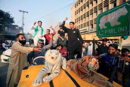 Supporters of the PMLN political party cheer on their candidate outside a polling station in Lahore, Pakistan September 17, 2017. REUTERS/Mohsin Raza