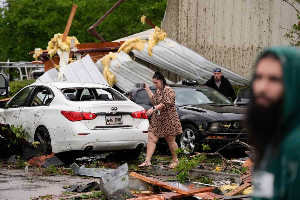 <p>AP Photo/Gerald Herbert</p> Robin Marquez walks past her son