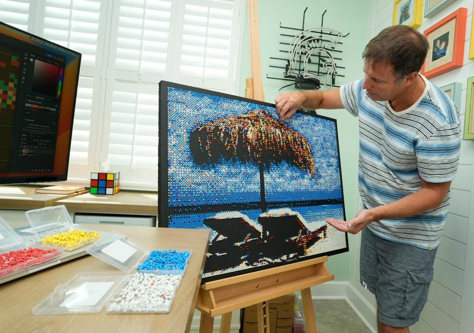 John Darovitz works on a pointillist art from his home studio in Daytona Beach, Monday, May 6, 2024.