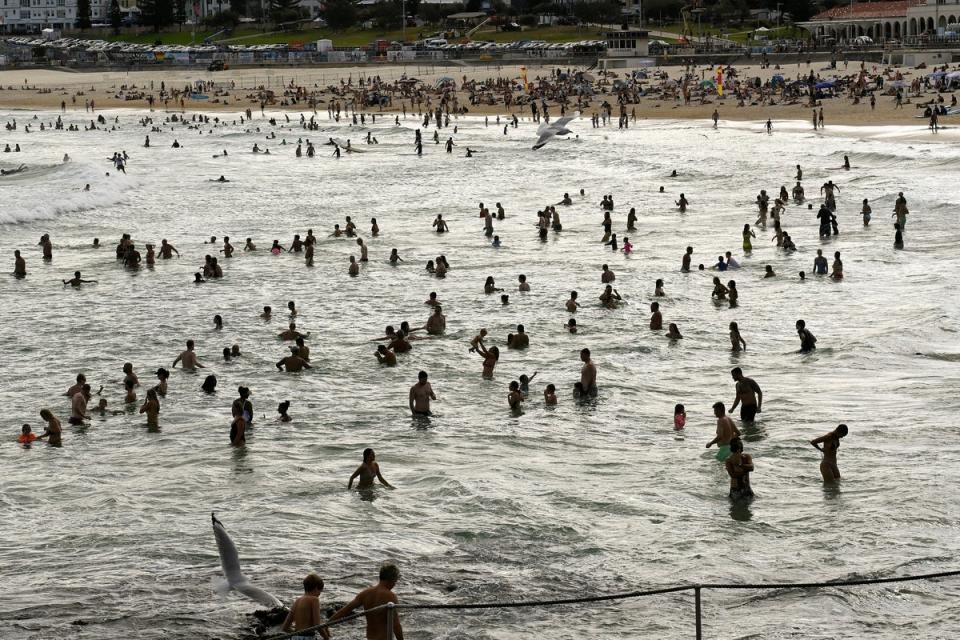 Crowds of people enjoy the water at the beach as parts of Australia’s east reached their hottest day in more than two years amid temperatures which rose to 40C (Reuters)