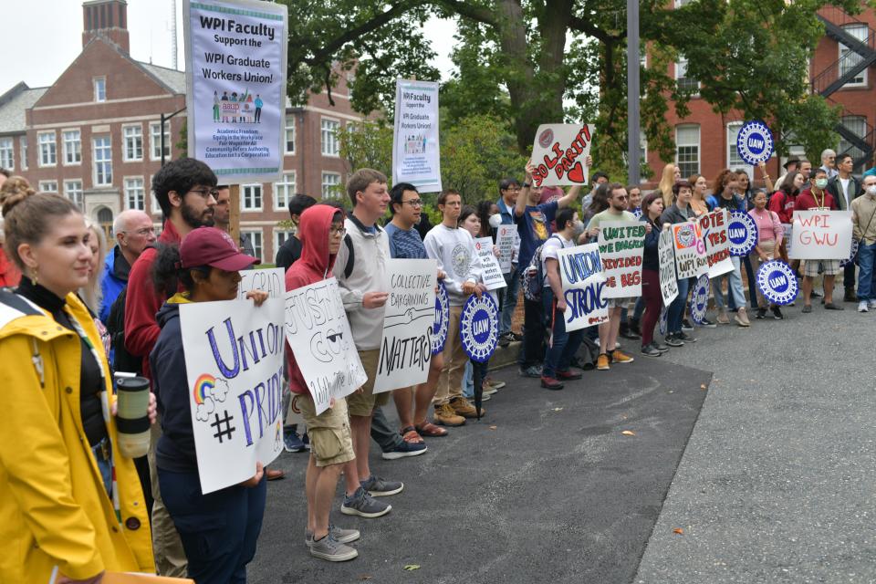 WPI graduate workers hold signs and rally to unionize Monday.