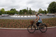 A cyclist uses the UK's first Dutch-style roundabout � which prioritises cyclists and pedestrians over motorists � after it opened in Fendon Road, Cambridge. The cost of the scheme, originally estimated at around GBP 800,000, has almost trebled to GBP 2.3m at the end of the project.