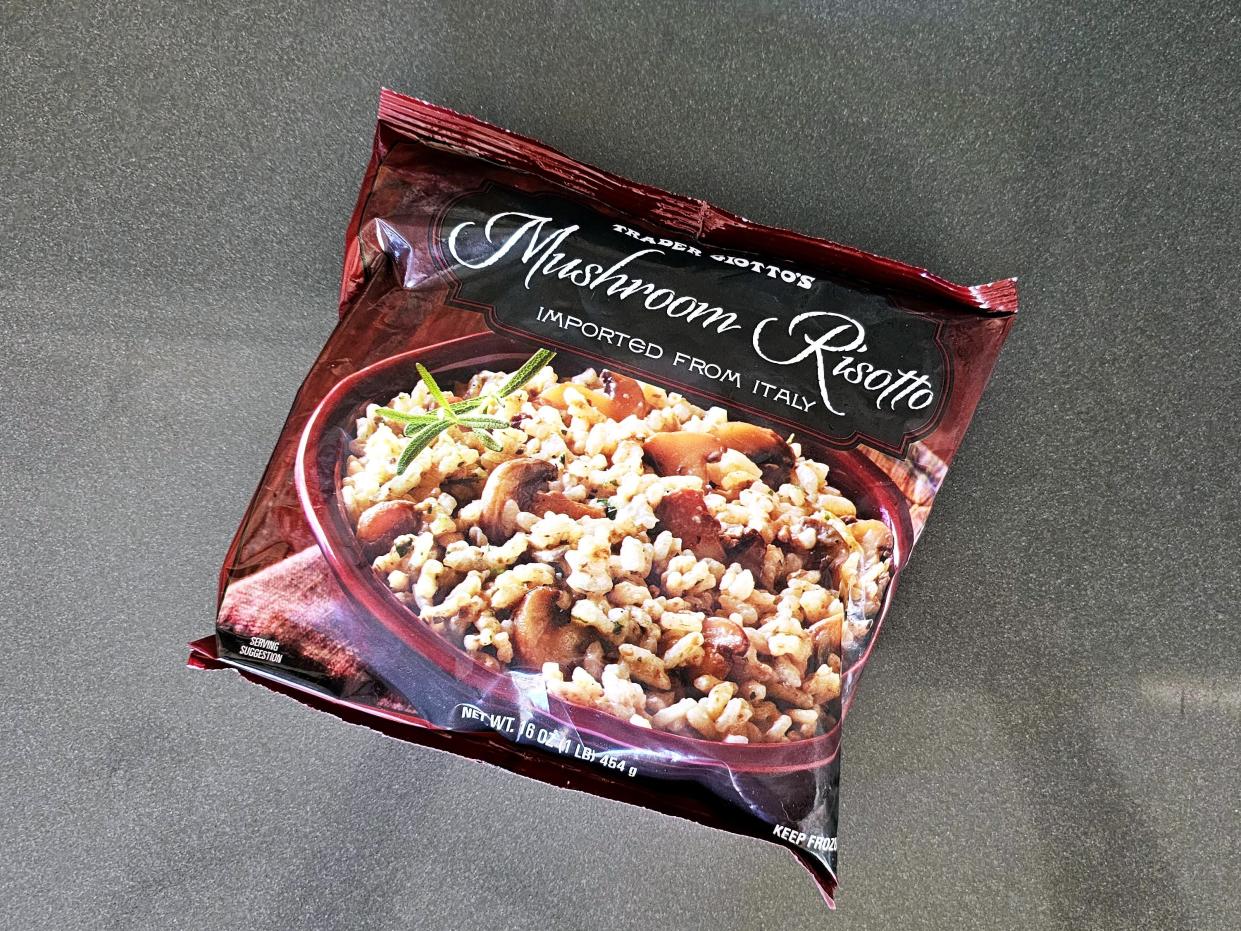 A bag of Trader Joe's mushroom risotto against a gray background.