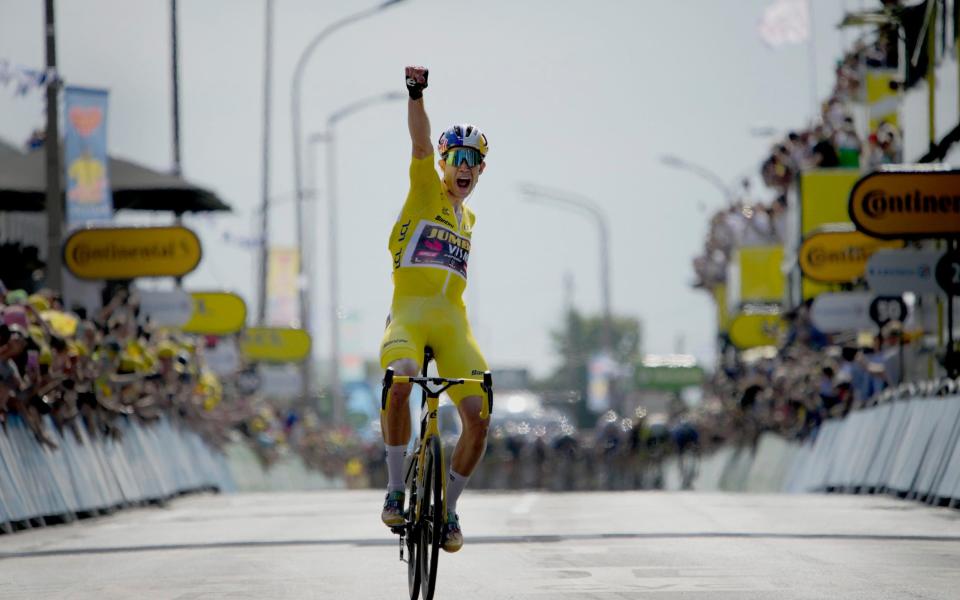 Belgium's Wout Van Aert, wearing the overall leader's yellow jersey celebrates as he crosses the finish line to win the fourth stage of the Tour de France cycling race over 171.5 kilometers (106.6 miles) with start in Dunkerque and finish in Calais, France, Tuesday, July 5, - AP