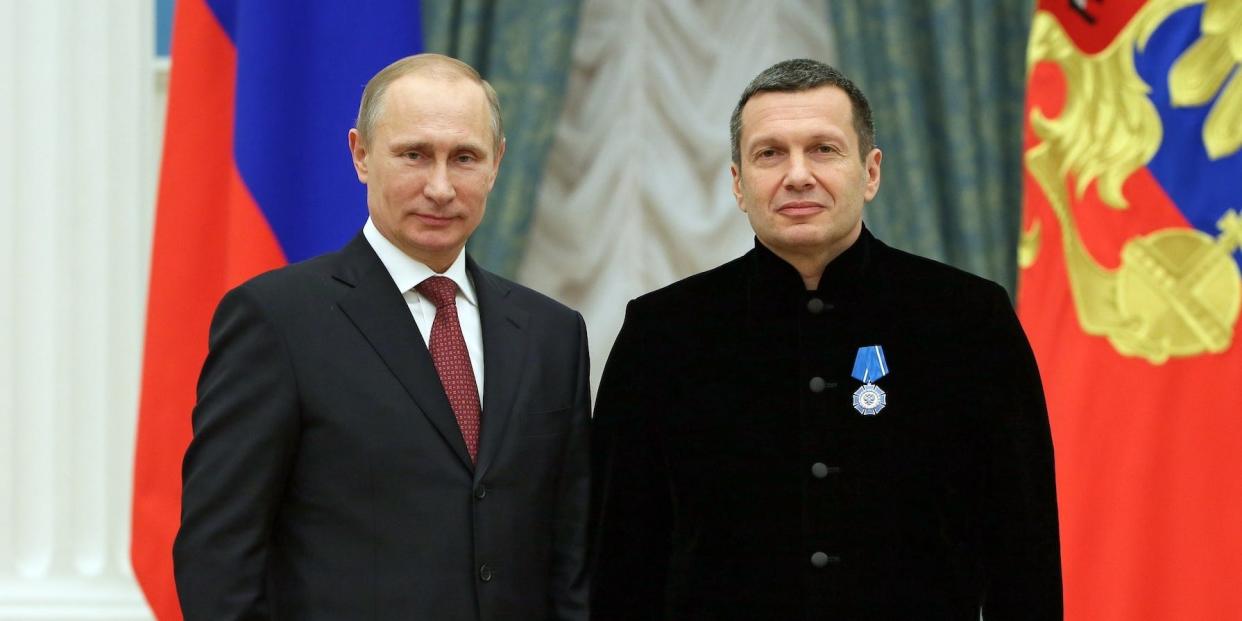 Russian President Vladimir Putin and television and radio host Vladimir Solovyov at an awards ceremony in Moscow, Russia, in December 2013.