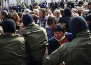 Women react, standing in front of police line during an opposition rally to protest the official presidential election results in Minsk, Belarus, Saturday, Sept. 12, 2020. Daily protests calling for the authoritarian president's resignation are now in their second month and opposition determination appears strong despite the detention of protest leaders. (Tut.by via AP)