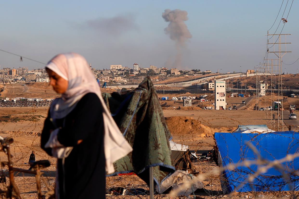 Smoke rises following an Israeli airstrike on buildings near the separating wall between Egypt and Rafah (AP)