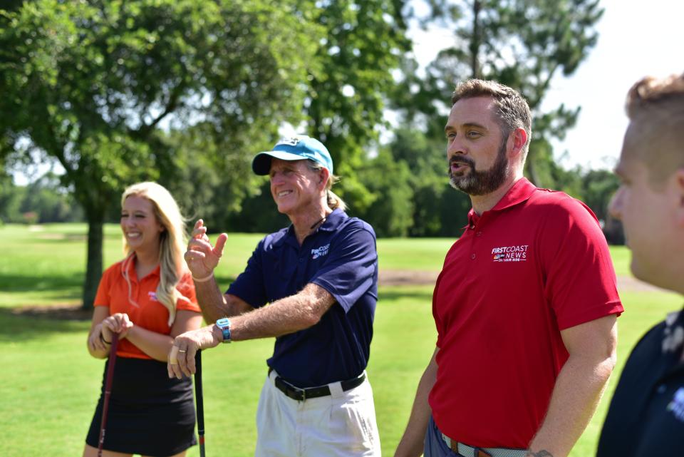 First Coast News meteorologists Tim Deegan (in blue shirt) and Lew Turner (in red), join fellow meteorologists Amelia Henderson and Robert Speta at a recent promotional event put on by the broadcasting company.