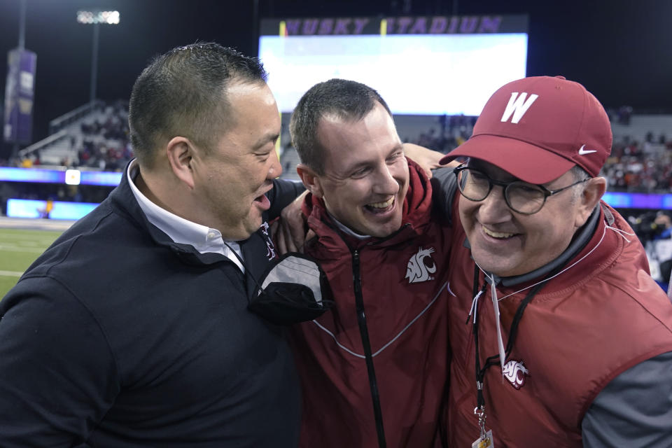 Washington State coach Jake Dickert, center, is joined by athletic director Pat Chun, left, and WSU President Kirk Schultz after WSU defeated Washington 40-13 in an NCAA college football game Friday, Nov. 26, 2021, in Seattle. (AP Photo/Ted S. Warren)