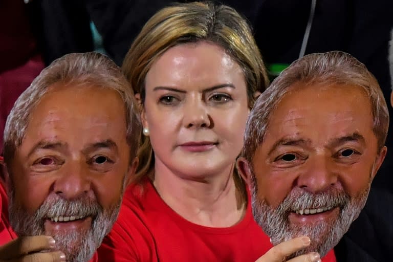 Gleisi Hoffmann, the head of jailed ex-president Luiz Inacio Lula da Silva's Workers Party, holding masks of the former leader, whose appeal against disqualification in October elections has been rejected by the Supreme Court