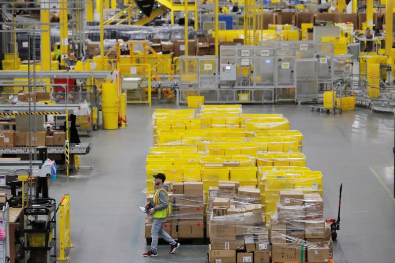 Amazon workers perform their jobs inside of an Amazon fulfillment center on Cyber Monday in Robbinsville, New Jersey