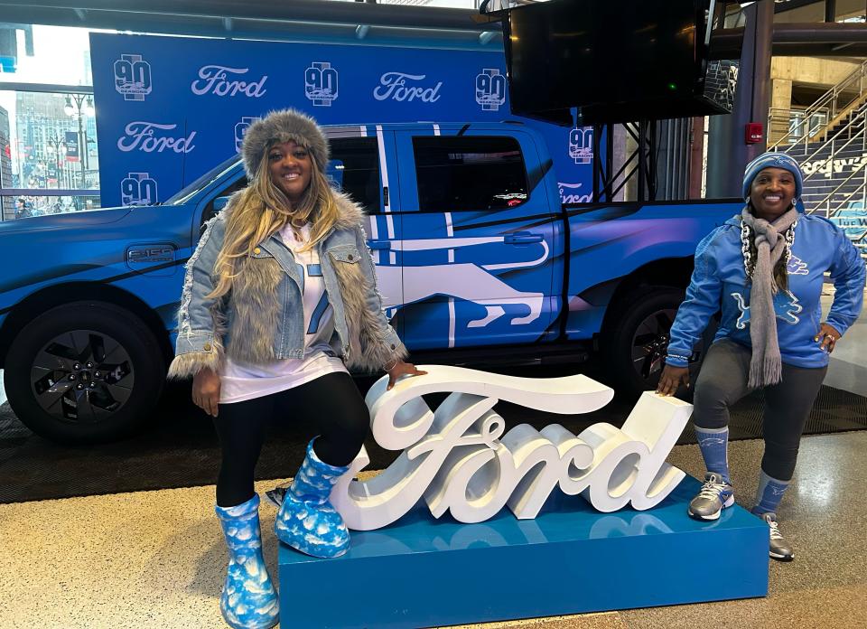 Malika Mason and her daughter, Nina Hand, pose in front of the Lions-wrapped Ford truck while waiting for friends to join them at the Lion's watch party at Ford Field on Sunday, Jan. 28, 2024.