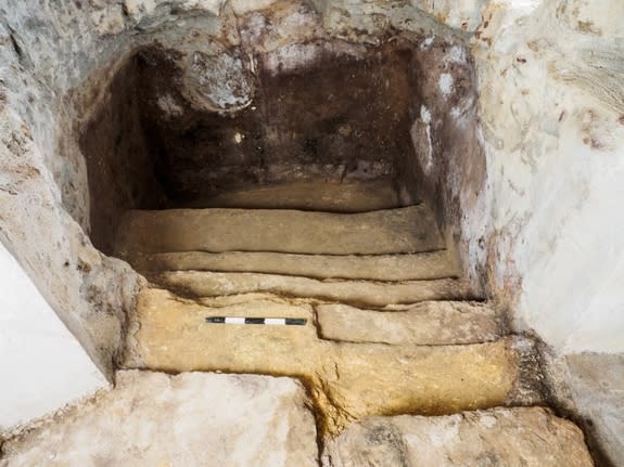 A staircase leads down to the 2,000-year-old ritual bath beneath floorboards in a family's living room.