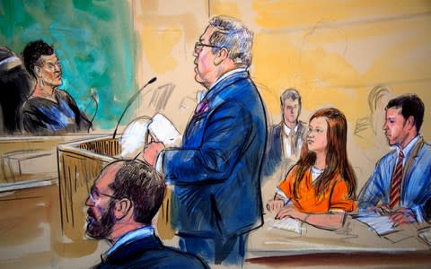 This courtroom sketch depicts Maria Butina, in orange suit, a 29-year-old gun-rights activist suspected of being a covert Russian agent - Credit: AP