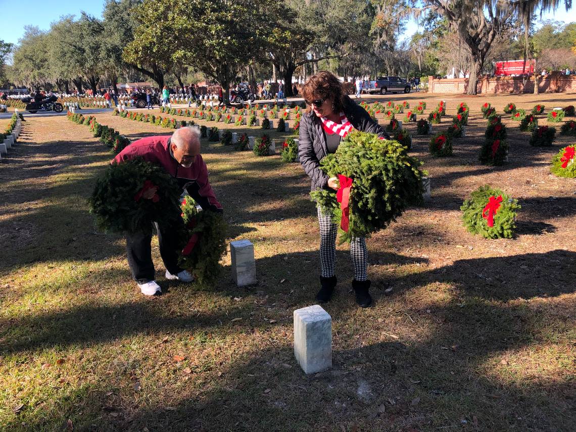 Joe Fulgieri and Lynn Crouse of Beaufort place wreaths at headstones at Beaufort National Cemetery in 2019.