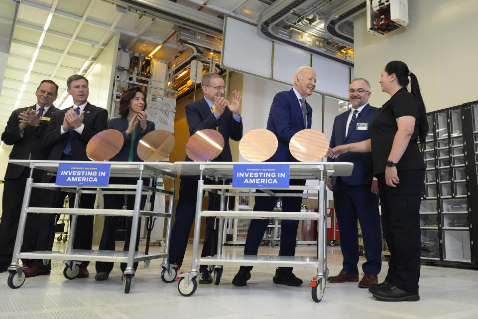 President Joe Biden shakes hands with Intel manufacturing technician Michelle Blackwell, as Intel CEO Pat Gelsinger, fourth from left, and Intel factory manager Hugh Green second from right watch, during a tour of the Intel Ocotillo Campus, in Chandler, Ariz., Wednesday March 20, 2024. (AP Photo/Jacquelyn Martin)