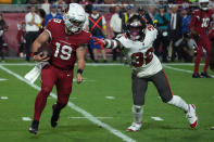 Arizona Cardinals quarterback Trace McSorley (19) scrambles as Tampa Bay Buccaneers safety Mike Edwards (32) defends during the first half of an NFL football game, Sunday, Dec. 25, 2022, in Glendale, Ariz. (AP Photo/Rick Scuteri)