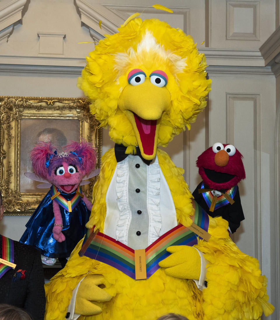 2019 Kennedy Center Honorees, Abby Cadabby, Big Bird, and Elmo, characters from "Sesame Street," pose for a photo following the Kennedy Center Honors State Department Dinner at the State Department on Saturday, Dec. 7, 2019, in Washington. (AP Photo/Kevin Wolf)