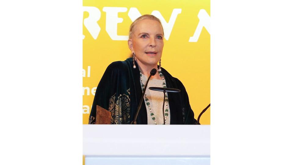 Princess Michael of Kent speaking in front of a yellow background