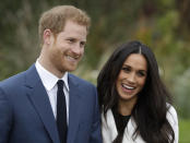 FILE - In this Monday Nov. 27, 2017 file photo, Britain's Prince Harry and his fiancee Meghan Markle pose for photographers during a photocall in the grounds of Kensington Palace in London. As the British royal family wrestles with the future roles of Prince Harry and his wife Meghan, it could look to Europe for examples of how princes and princesses have tried to carve out careers away from the pomp and ceremony of their families’ traditional duties. (AP Photo/Matt Dunham, File)