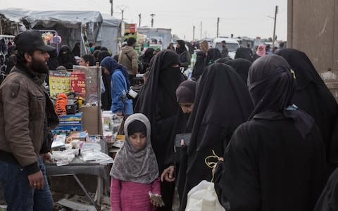 Residents of a camp for people who lived under ISIS and are now displaced shop at a market area of a camp run by Kurdish authorities in Al Hol - Credit: Sam Tarling/The Telegraph