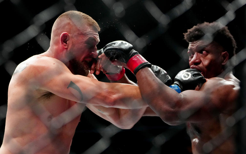 Dec 16, 2023; Las Vegas, Nevada, USA; Alonzo Menifield (red gloves) fights Dustin Jacoby (blue gloves) during UFC 296 at T-Mobile Arena. Mandatory Credit: Stephen R. Sylvanie-USA TODAY Sports