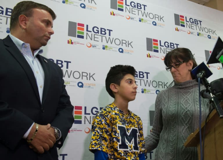 New York LGBT Network CEO David Kilmnick (L), looks on as Lauren Bocketti (R) and her transgender son Zach (C) speak at a press conference on February 23, 2017 in Woodbury, New York