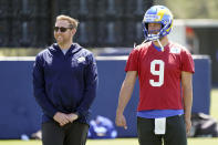 Los Angeles Rams offensive coordinator Liam Coen, left, smiles next to quarterback Matthew Stafford (9) at the NFL football team's practice facility Monday, May 23, 2022, in Thousand Oaks, Calif. (AP Photo/Marcio Jose Sanchez)