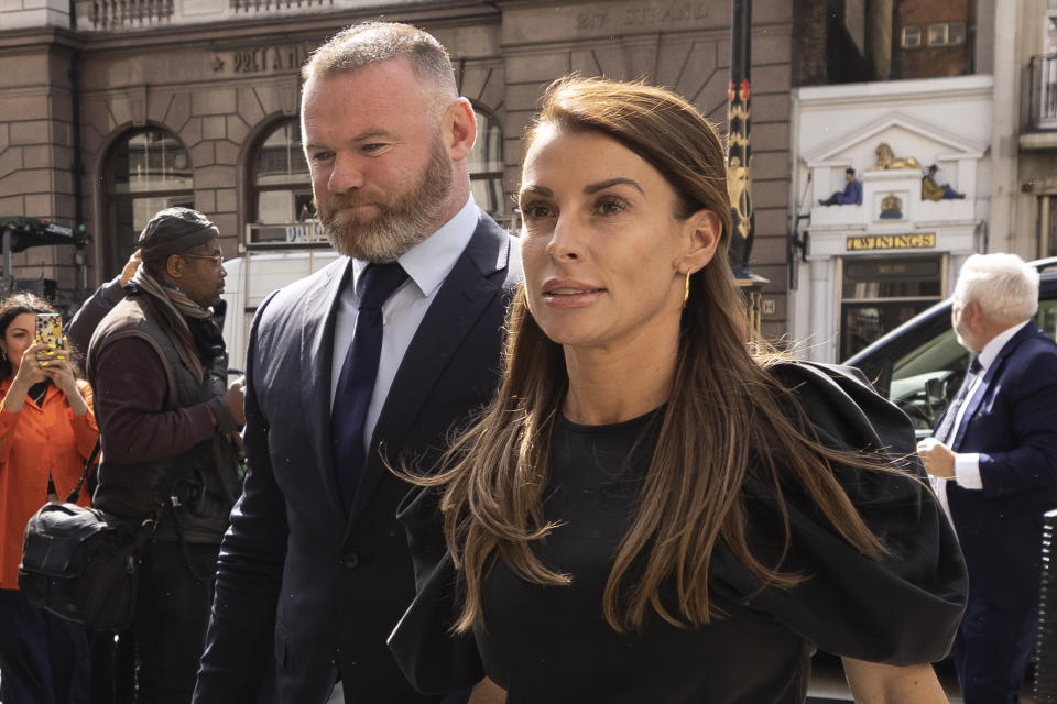 Coleen Rooney arrives with husband Wayne Rooney at Royal Courts of Justice, Strand on May 12, 2022 in London, England. Coleen Rooney, wife of Derby County manager and former England football player Wayne Rooney, and Rebekah Vardy, wife of Leicester City striker Jamie Vardy, are locked in a libel battle dubbed by the media as the 