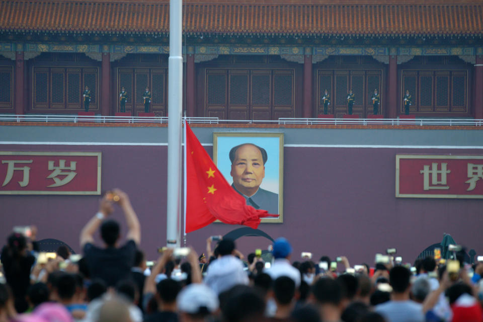 Thousands of tourists watch the national flag raising ceremony at Tian'anmen Square on the 97th anniversary of the Communist Party of China (CPC) on July 1, 2018 in Beijing, China. 